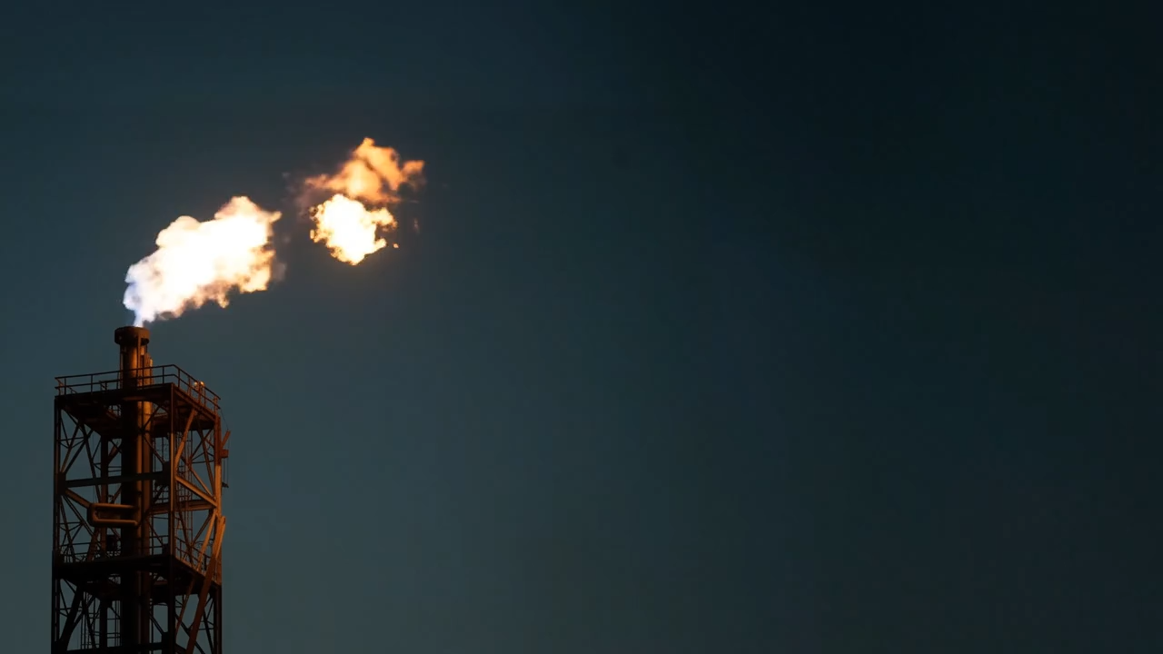 Industrial flare stack at night